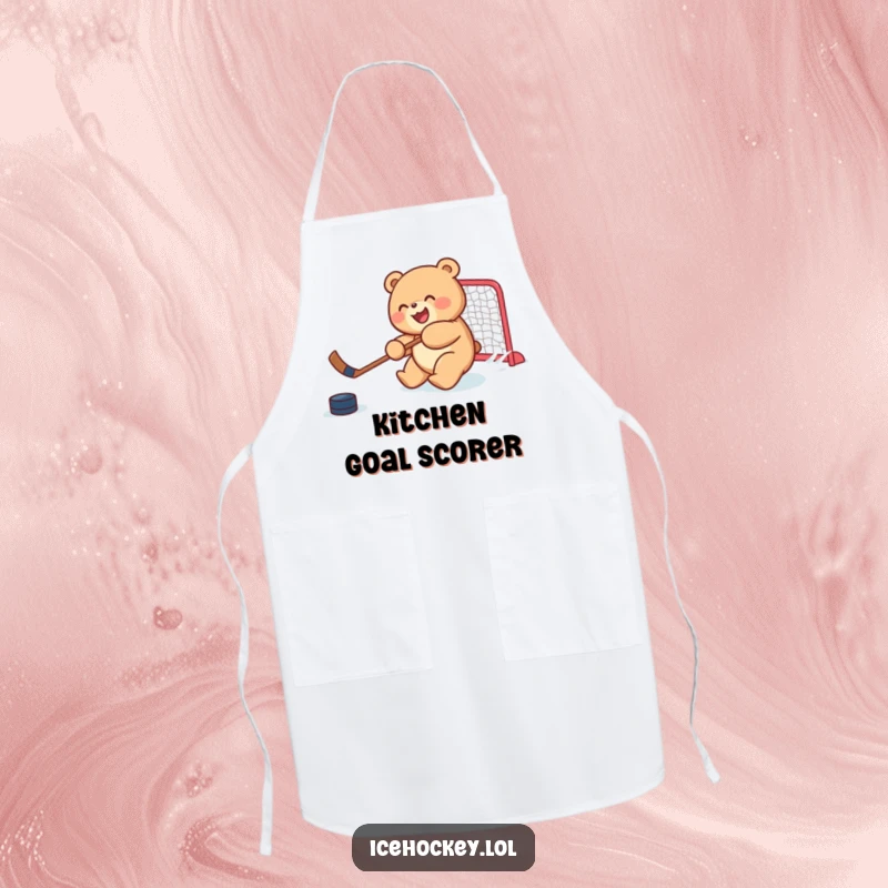 Funny apron showcasing a joyful, round bear cub skillfully shooting a hockey puck, ideal for a humorous cooking experience.