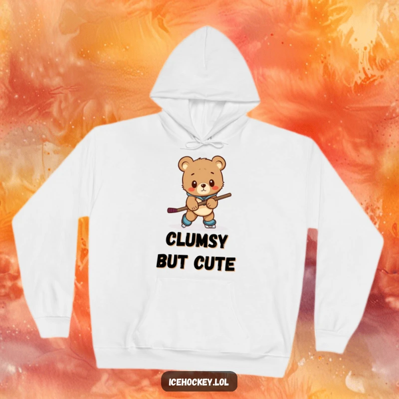 Funny hoodie showing a curious bear cub struggling to skate with a hockey stick that is far too large for it.