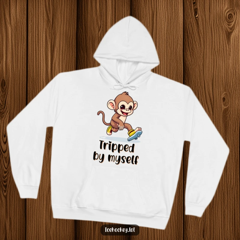 Funny hoodie with a mischievous monkey falling awkwardly while ice skating, tripping over skates. Cozy humor.