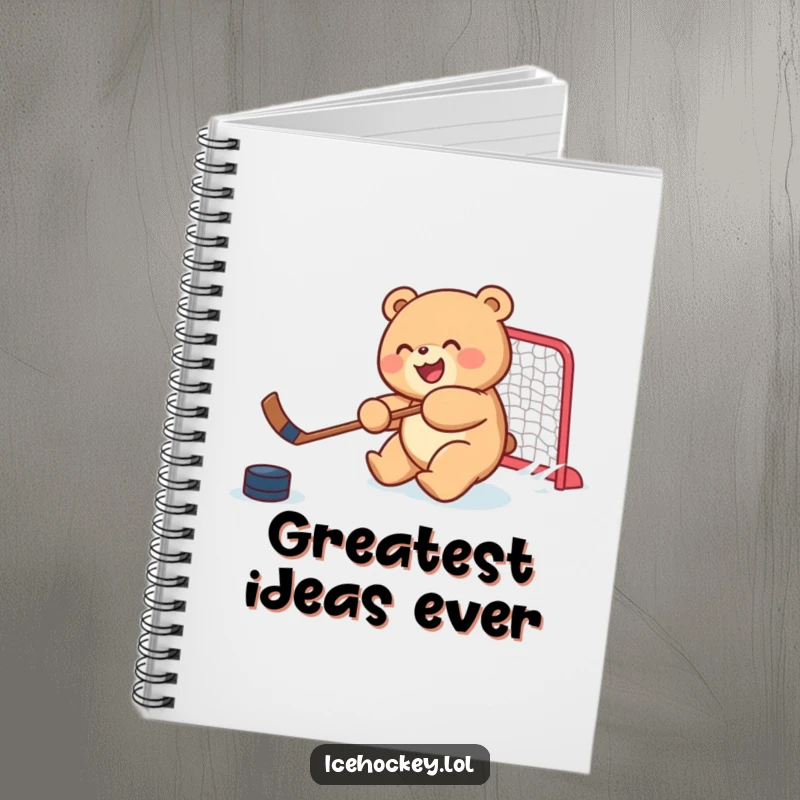 Funny notebook featuring a joyful, round bear cub skillfully shooting a hockey puck, perfect for jotting notes humorously.