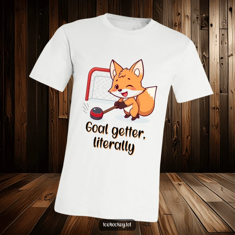 Funny t-shirt featuring a smiling, determined fox intensely shooting a hockey puck, embodying sports spirit and humor.
